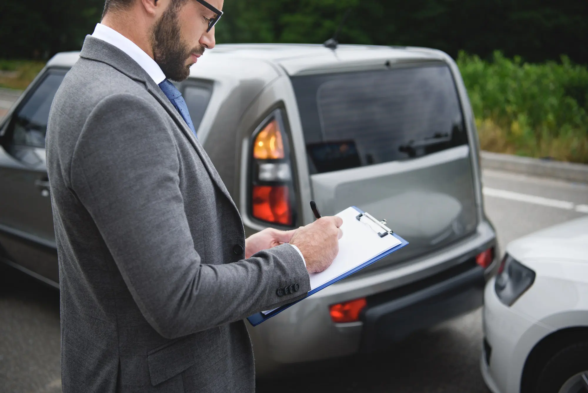 Driver reviewing paperwork after arranging pay-as-you-go vehicle recovery