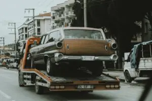 Recovery tow truck loading a car during vehicle recovery in Newcastle-under-Lyme
