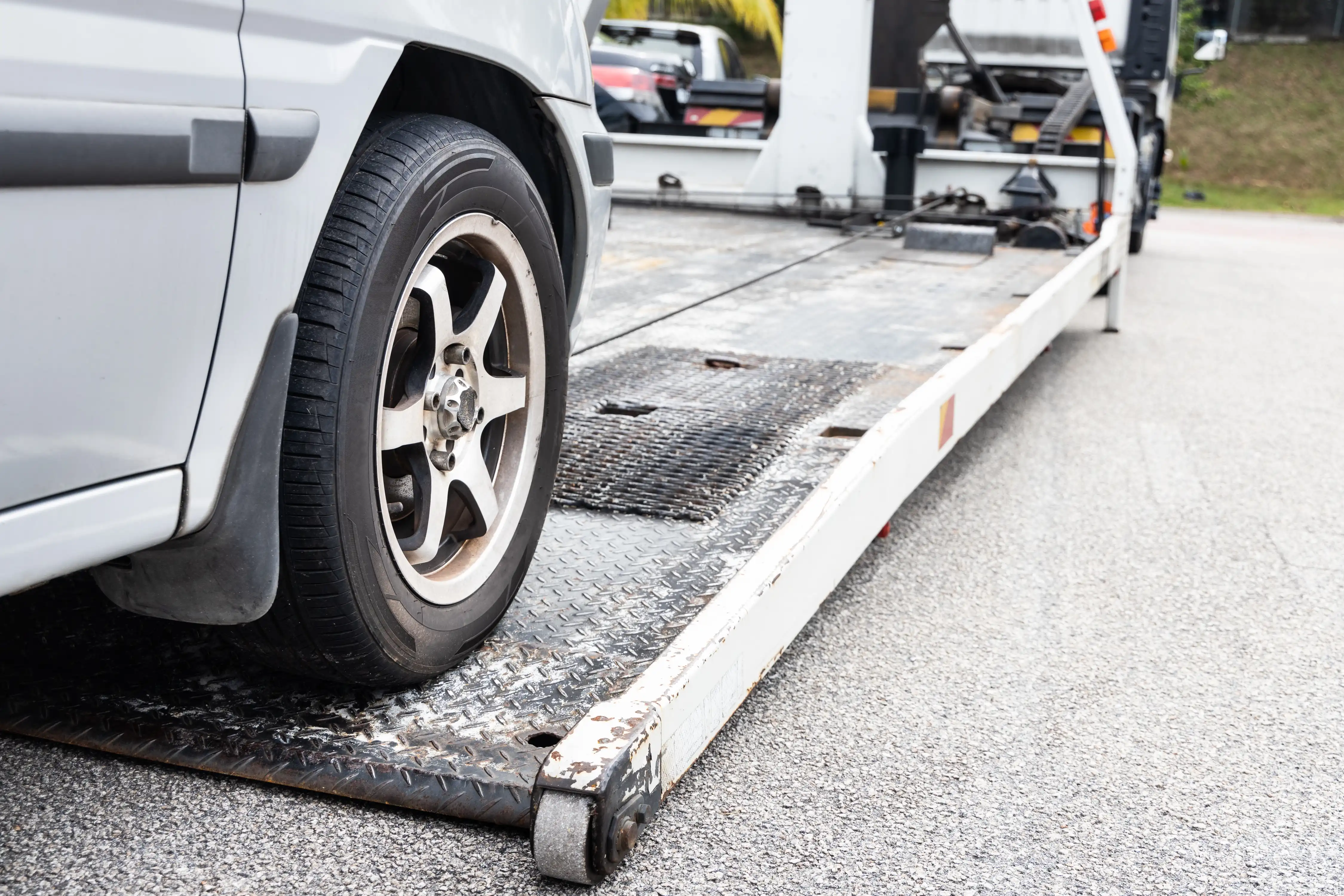 Vehicle being loaded onto a recovery truck for long distance transportation