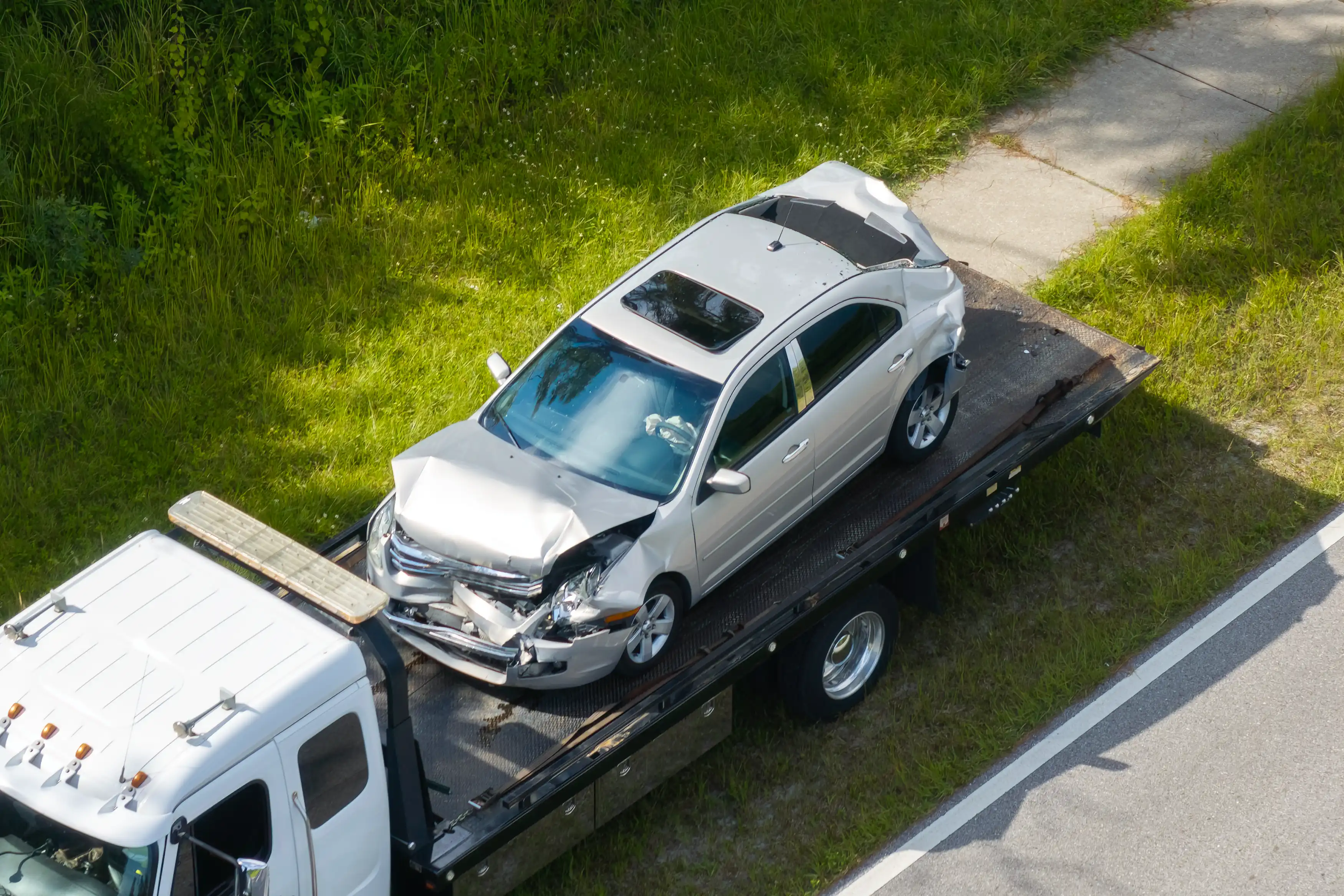 Vehicle being transported long distance on a Fast Track Recovery flatbed truck
