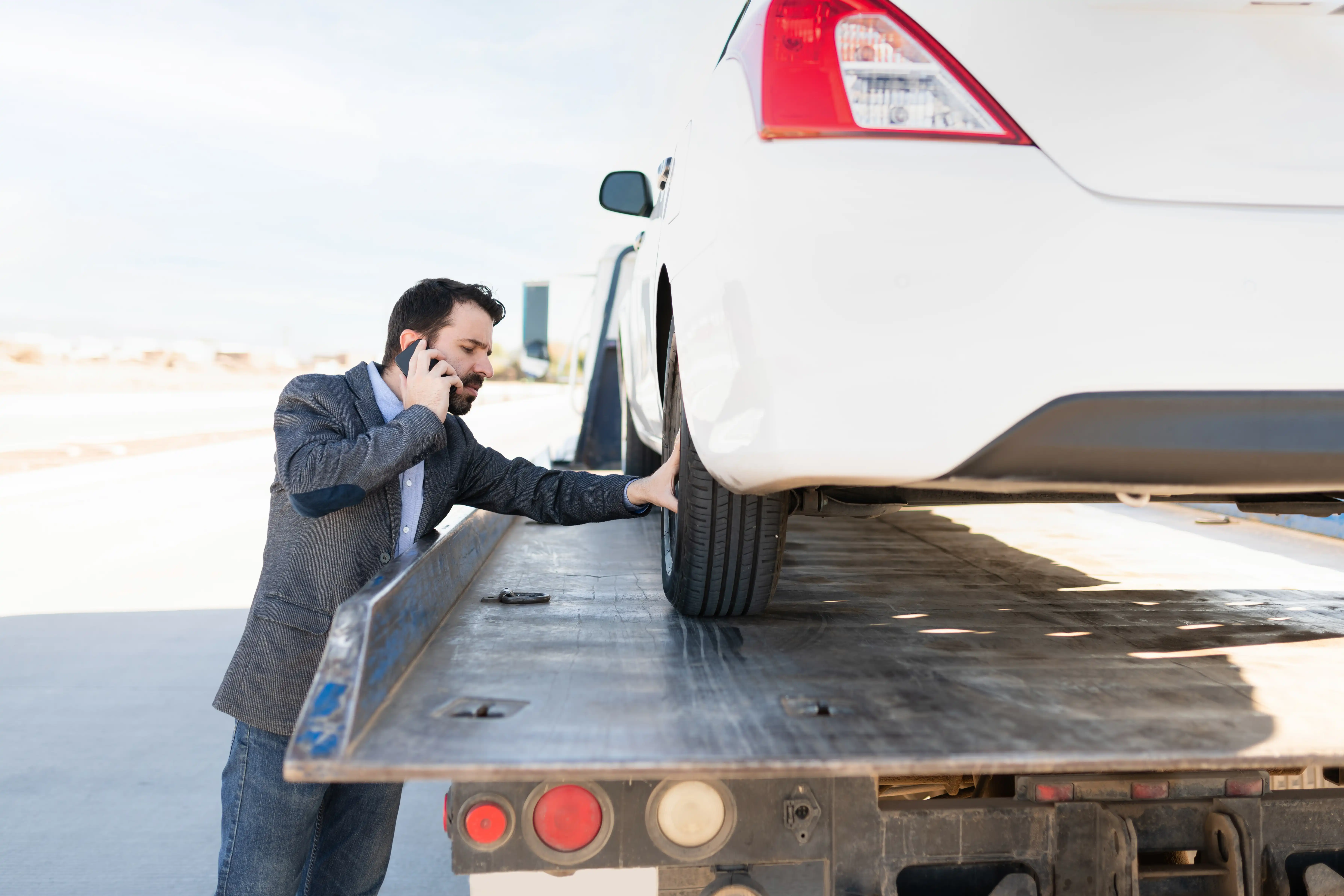 Customer calling Fast Track Recovery while their car is loaded onto the recovery truck